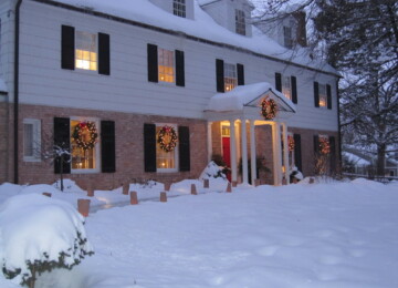 Home decorated for Christmas with wreaths and luminaries