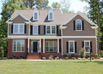 Brown house with black shutters on a sunny day