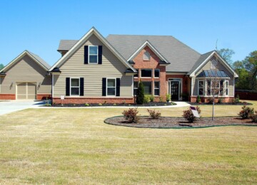 Home with green siding and red brick